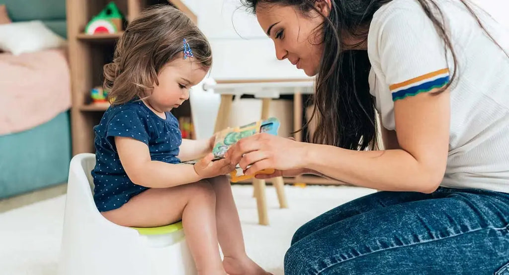 Madre leyendo un cuento a un niño en el orinal